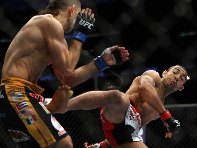Jose Aldo, right, of Brazil and Ricardo Lamas of Chicago, IL fight in the first round of the Ultimate Fighting Featherweight Championship Mix Martial Arts bout in Newark, N.J. on Saturday, Feb. 1, 2014. Aldo won by unanimous decision in five rounds. (AP Photo/Tim Larsen)